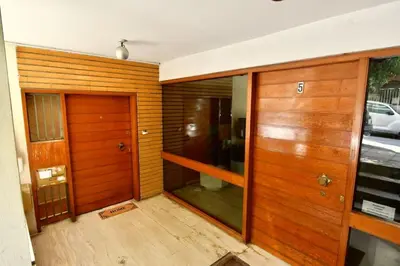 an empty room with wooden doors and wooden floors at Kolonaki Spacious 1 Bd Apt with Outdoor Patio in Athens