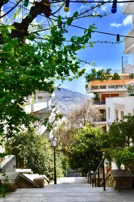a street in a city with buildings and trees at Kolonaki Spacious 1 Bd Apt with Outdoor Patio in Athens