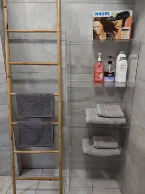 a ladder shelf in a bathroom with towels at Kolonaki Spacious 1 Bd Apt with Outdoor Patio in Athens