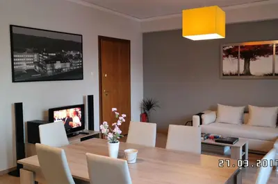 a living room with a table and a couch at Comfy Apartment With Acropolis View in Athens