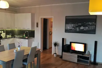 a living room with a television and a dining table at Comfy Apartment With Acropolis View in Athens