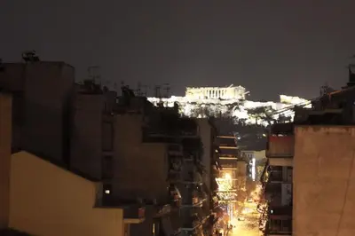 a view of a city at night with the acropolis at Comfy Apartment With Acropolis View in Athens