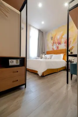 a bedroom with a bed and a dresser with a mirror at Athens Market Portrait in Athens
