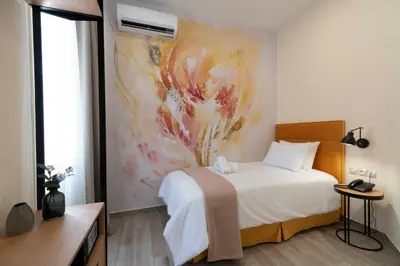 a bedroom with a bed and a painting on the wall at Athens Market Portrait in Athens