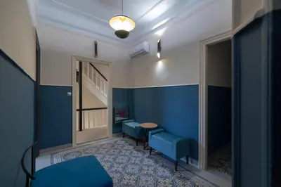 a room with blue walls and a table and chairs at Athens Market Portrait in Athens