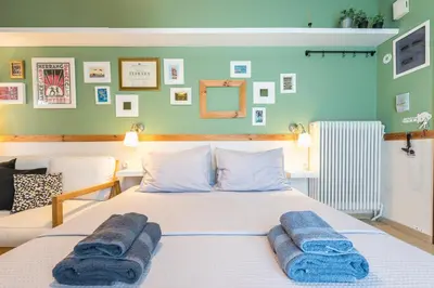 a bedroom with a bed with blue towels on it at Acropolis view under the stars! in Athens