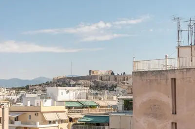 a view of a city from a building at Acropolis view under the stars! in Athens