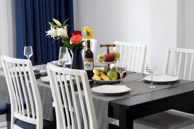 a dining room table with a bowl of fruit and wine glasses at Brand new apartment in the heart of the city in Athens
