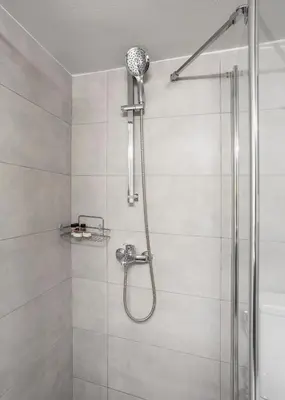 a shower with a shower head in a bathroom at Brand new apartment in the heart of the city in Athens