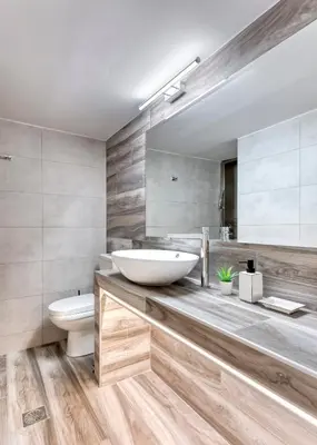 a bathroom with a sink and a toilet and a mirror at Brand new apartment in the heart of the city in Athens