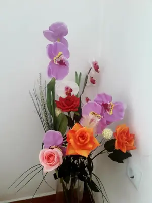 a vase filled with colorful flowers on a wall at Αnna's Home 2 .Holidays in beautiful Athens in Athens