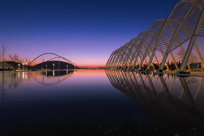 a bridge over a body of water at night at Αnna's Home 2 .Holidays in beautiful Athens in Athens