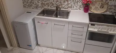 a white kitchen with a sink and a dishwasher at Αnna's Home 2 .Holidays in beautiful Athens in Athens
