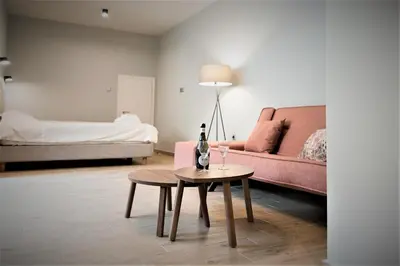 a living room with a couch and a table at Beautiful studio next to ancient stadium in Athens