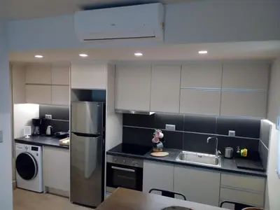 a kitchen with a stainless steel refrigerator and a sink at Beautiful studio next to ancient stadium in Athens
