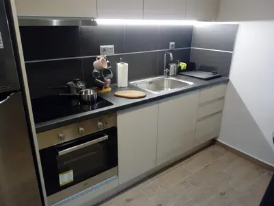 a small kitchen with a sink and a stove at Beautiful studio next to ancient stadium in Athens
