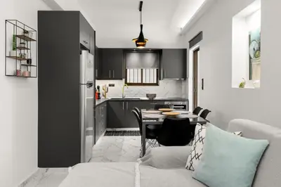a living room with a table and a kitchen at Luxury apartment in Glyfada(near metro station)C82 in Athens