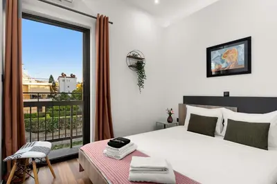 a bedroom with a bed and a large window at Luxury apartment in Glyfada(near metro station)C82 in Athens