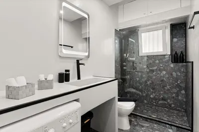 a white bathroom with a shower and a toilet at Luxury apartment in Glyfada(near metro station)C82 in Athens