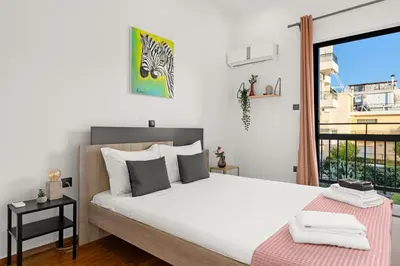 a bedroom with a bed and a large window at Luxury apartment in Glyfada(near metro station)C82 in Athens