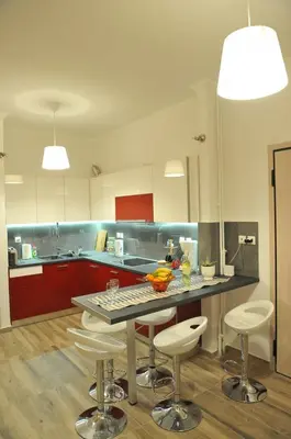 a kitchen with a table and some stools in it at Cozy ACROPOLIS in Athens
