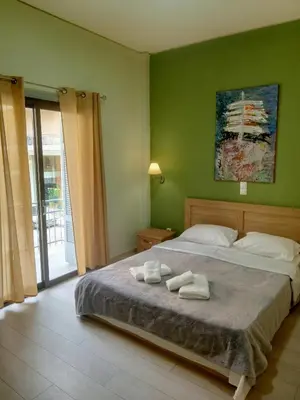 a bedroom with a bed with two towels on it at Koukaki-Acropolis roomy with a private veranda apt. in Athens
