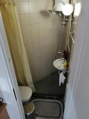 a small bathroom with a toilet and a sink at Spacious & Modern Studio Apartment Near the Airport in Glyka Nera