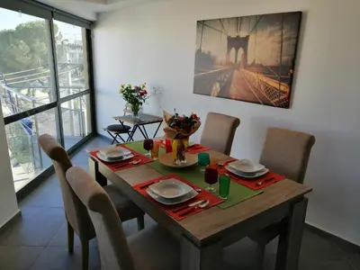 a dining room with a table with chairs and a tableablish at Spacious & Modern Studio Apartment Near the Airport in Glyka Nera