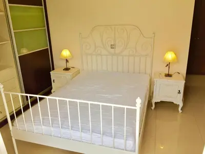 a bedroom with a white bed and two night stands at Modern apartment near Athens&Coast in Keratea