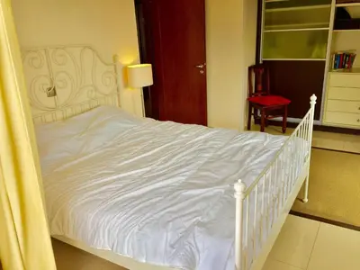 a bedroom with a white bed with a white bed frame at Modern apartment near Athens&Coast in Keratea