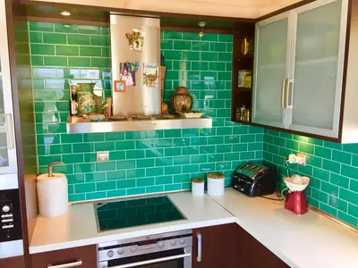 a kitchen with green tiles on the wall at Modern apartment near Athens&Coast in Keratea
