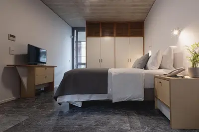 a bedroom with a bed and a television in it at Athens BlueBuilding in Athens