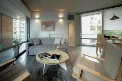 a living room with a couch and a table at Athens BlueBuilding in Athens