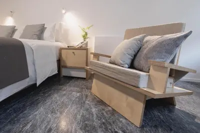 a bedroom with a couch next to a bed at Athens BlueBuilding in Athens