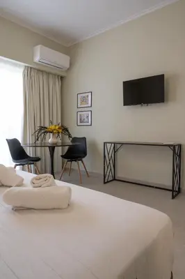 a bedroom with a bed and a flat screen tv at ATHENS STORIES in Athens