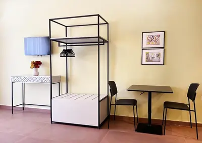 a room with a table and a book shelf at ATHENS STORIES in Athens