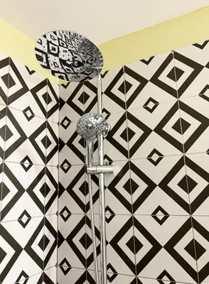 a shower in a bathroom with black and white tiles at ATHENS STORIES in Athens