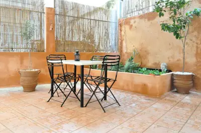 a table and chairs in a patio with plants at Courtyard Apt - Central Athens in Athens