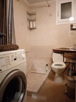 a bathroom with a toilet and a washing machine at Courtyard Apt - Central Athens in Athens