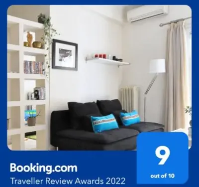 a living room with a black couch in a room at Courtyard Apt - Central Athens in Athens