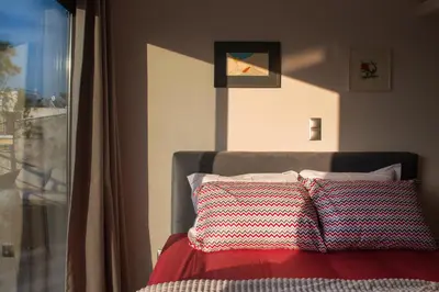 a bedroom with a bed with two pillows on it at Acropolis View Rooftop Apartment Athens in Athens