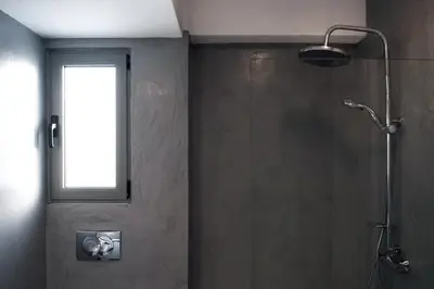 a bathroom with a shower with a window at Acropolis View Rooftop Apartment Athens in Athens