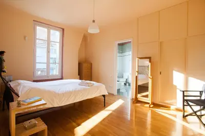 a bedroom with a bed and a bathroom at House at the Foothills of Acropolis in Athens