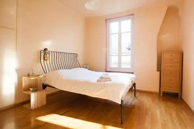 a bedroom with a bed and a window at House at the Foothills of Acropolis in Athens