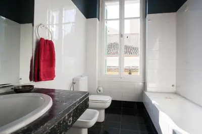 a bathroom with a tub and a toilet and a sink at House at the Foothills of Acropolis in Athens