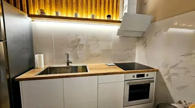a small kitchen with a sink and a stove at Boutique Athensairport Apartments in Markopoulo
