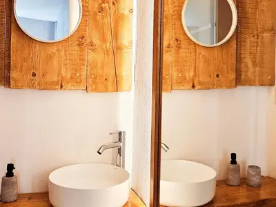 a bathroom with two mirrors and a white sink at Boutique Athensairport Apartments in Markopoulo