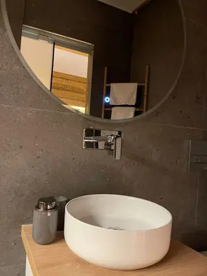 a bathroom with a white sink and a mirror at Boutique Athensairport Apartments in Markopoulo