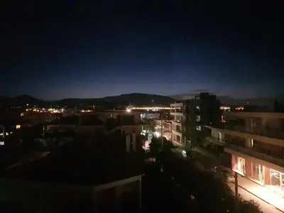 a view of a city at night with buildings at Boutique Athensairport Apartments in Markopoulo