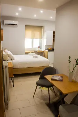 a bedroom with a bed and a desk and a table at 12 Keys Athens Apartments in Athens